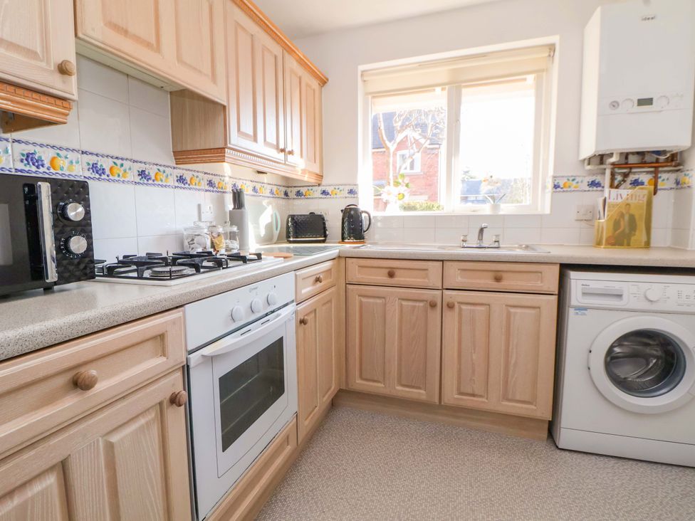 A kitchen with appliances and cabinets at 10 Church Walks Chester