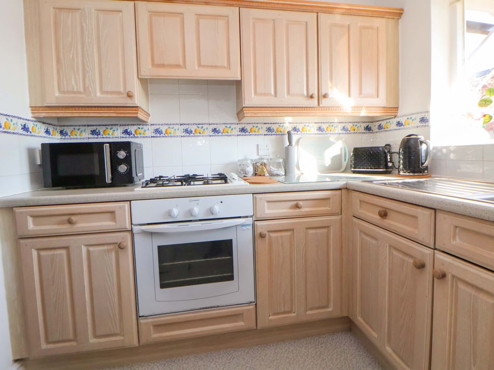 A kitchen with cabinets appliances and a sink at 10 Church Walks in Chester