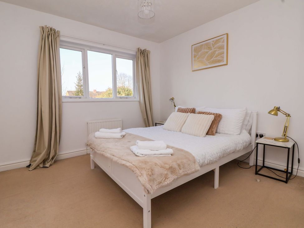 A bedroom with a bed and curtains at 10 Church Walks in Chester