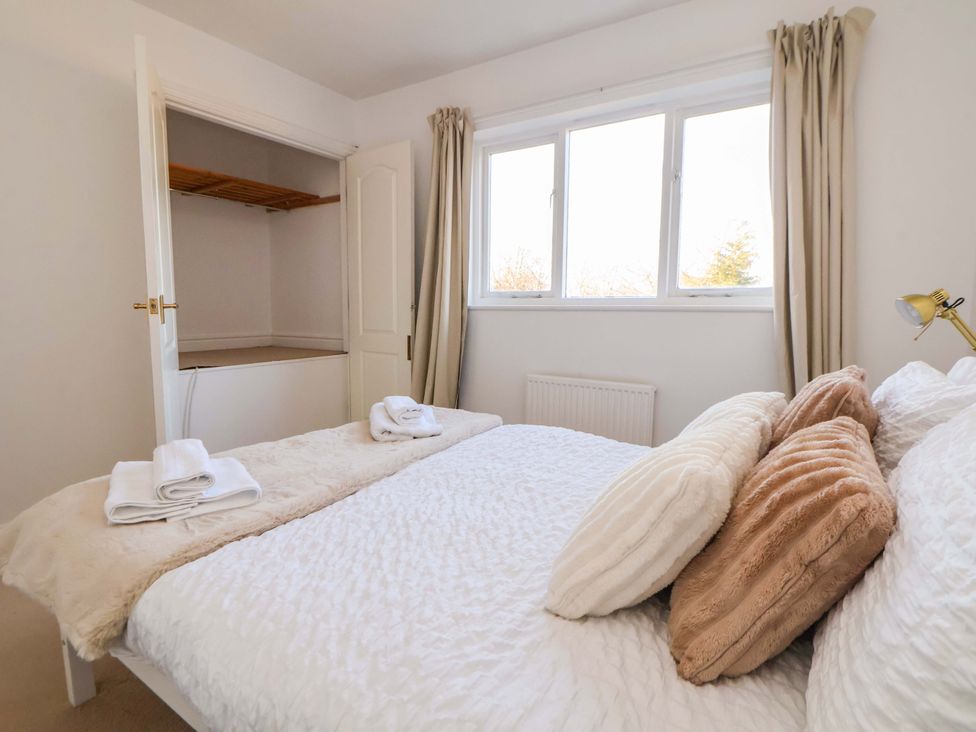 A bedroom with a bed and wardrobe at 10 Church Walks in Chester