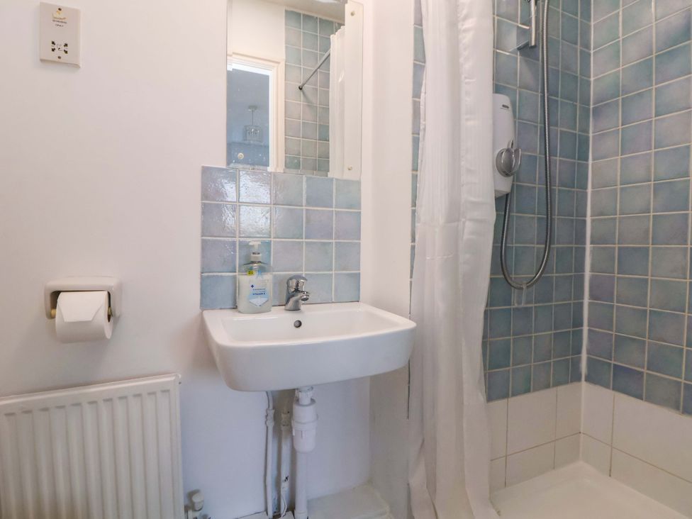 A bathroom with a sink and shower at 10 Church Walks in Chester