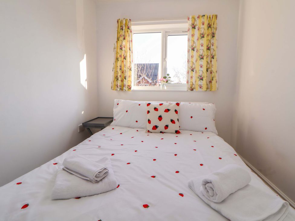 A bedroom with a bed and window at 10 Church Walks Chester