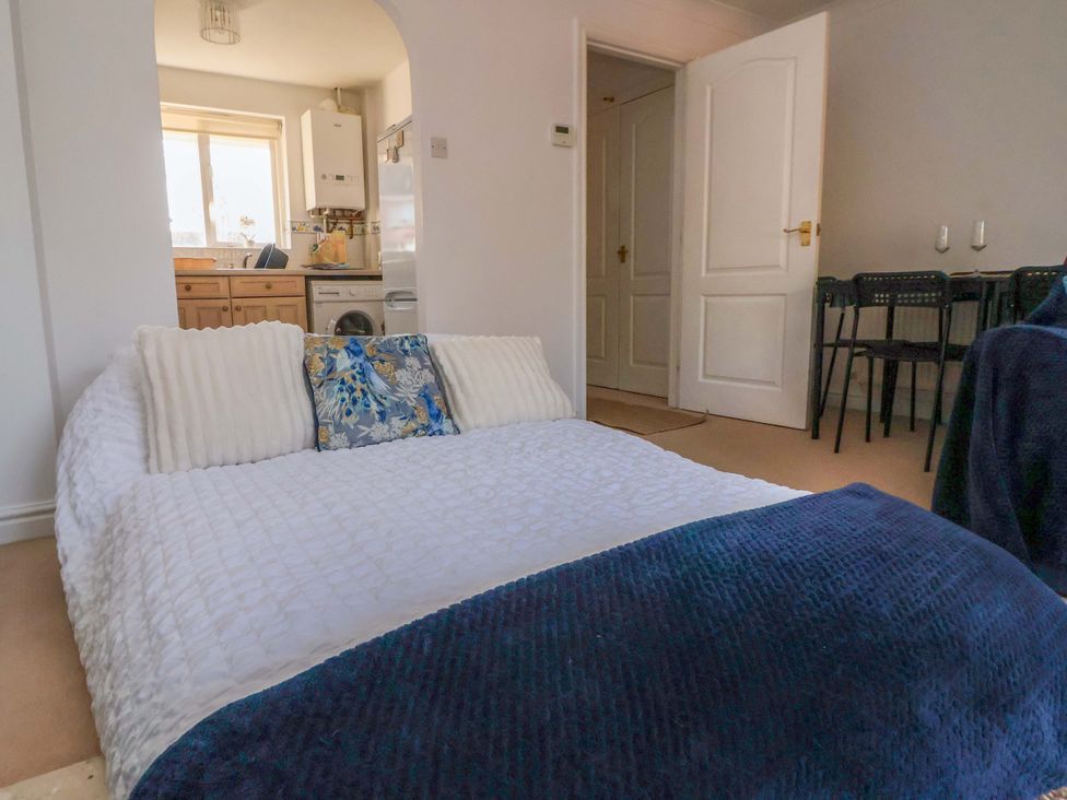 A living room with a sofa and dining area at 10 Church Walks Chester