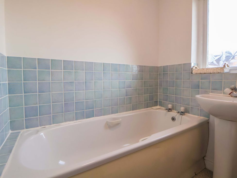 A bathroom with a bathtub and sink at 10 Church Walks in Chester