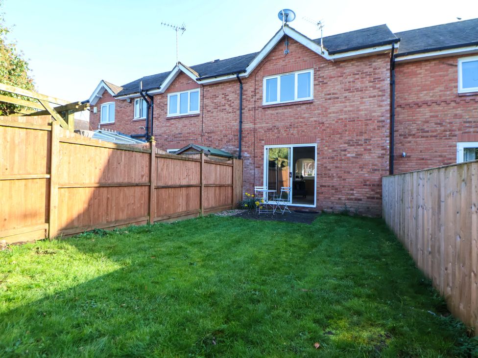 A backyard with grass and a fence at 10 Church Walks Chester