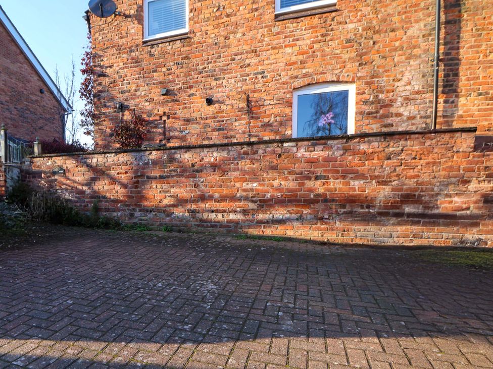 An outdoor area with a brick wall and window at 10 Church Walks Chester