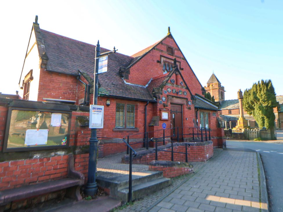 A brick building with steps and signs at 10 Church Walks Chester