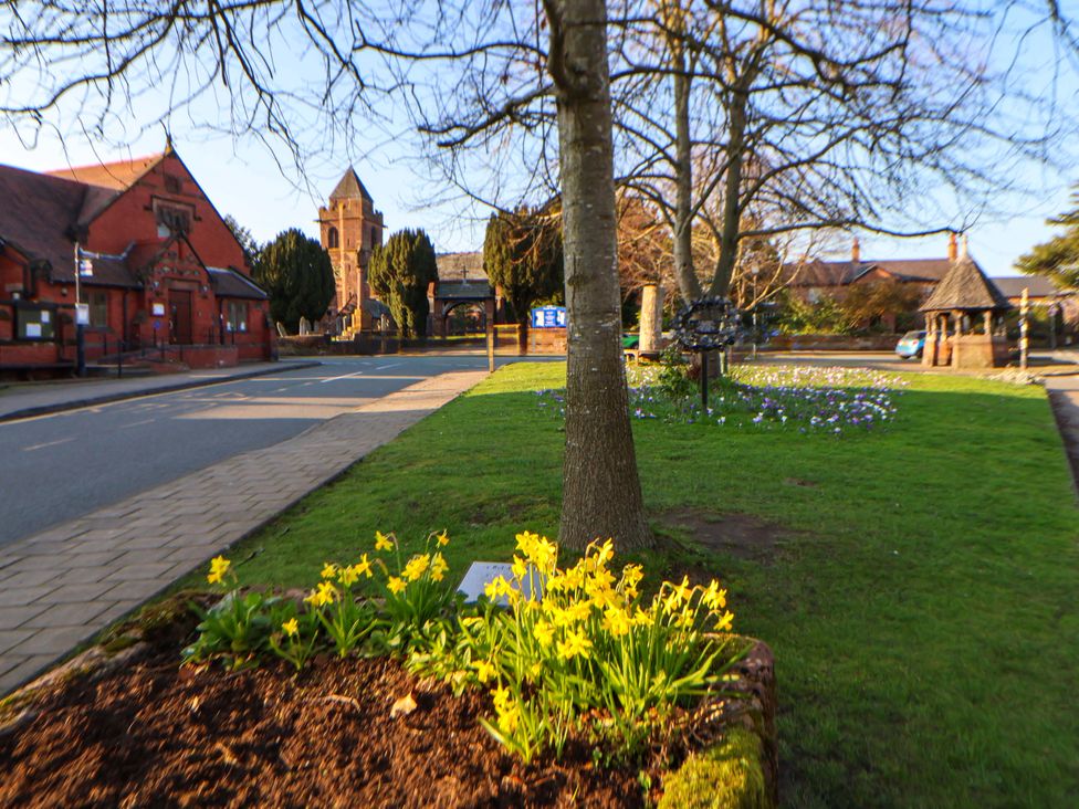 A street view with buildings and flowers at 10 Church Walks Chester