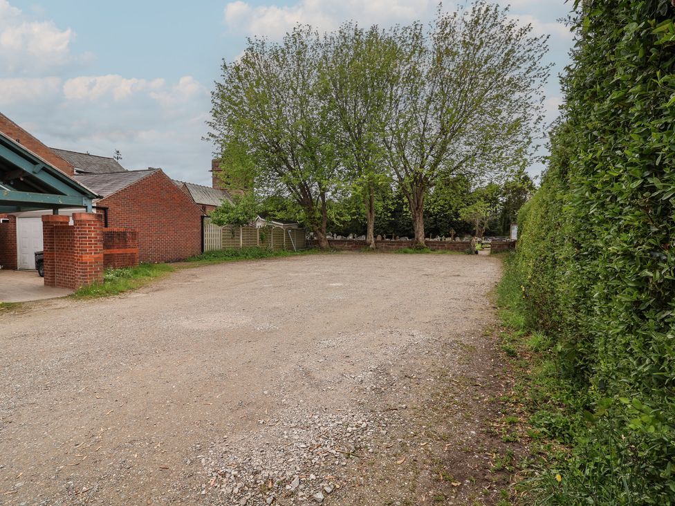 An outdoor area with gravel and trees at 10 Church Walks in Christleton