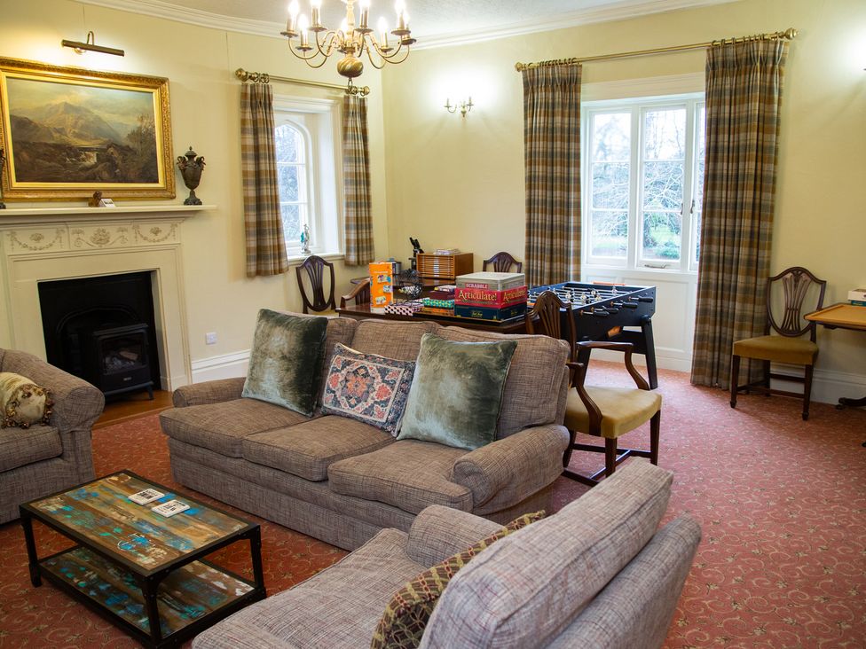 A living room with a sofa and coffee table at Uphill Manor in Uphill near Weston-Super-Mare