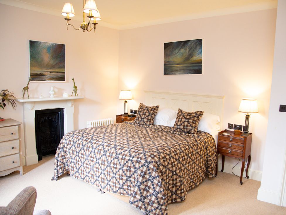A bedroom with a bed and bedside tables at Uphill Manor in Uphill near Weston-Super-Mare