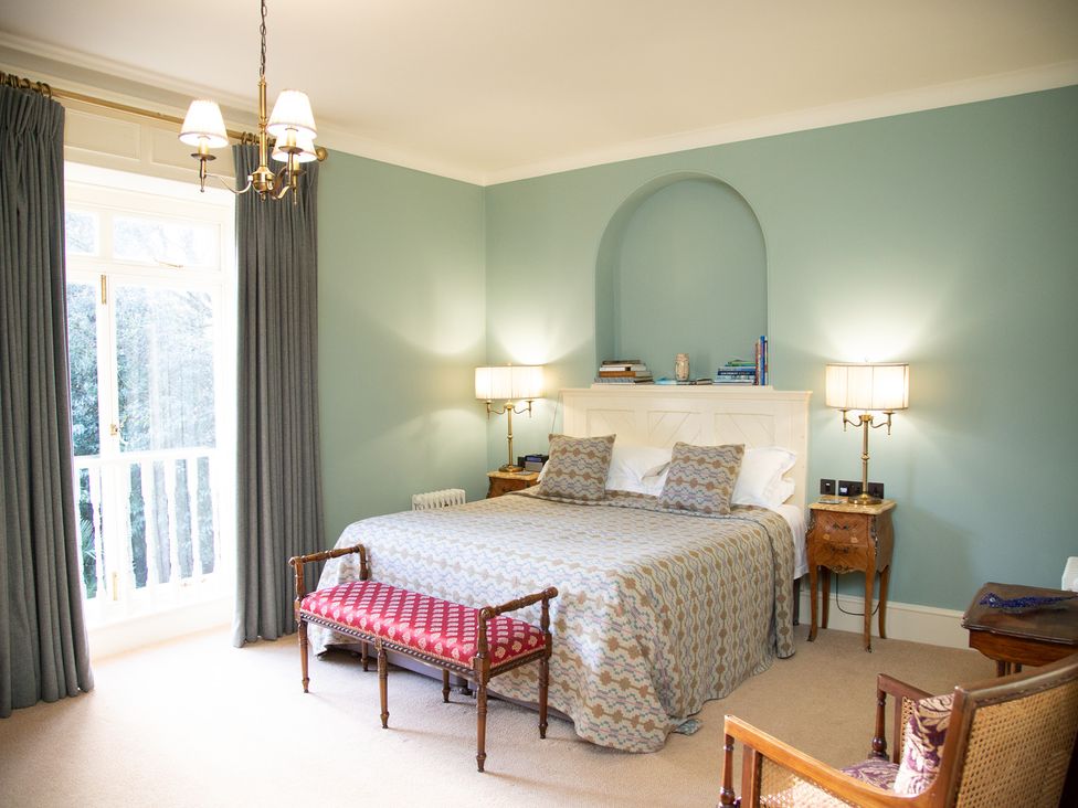 A bedroom with a bed and bedside tables at Uphill Manor in Uphill near Weston-Super-Mare