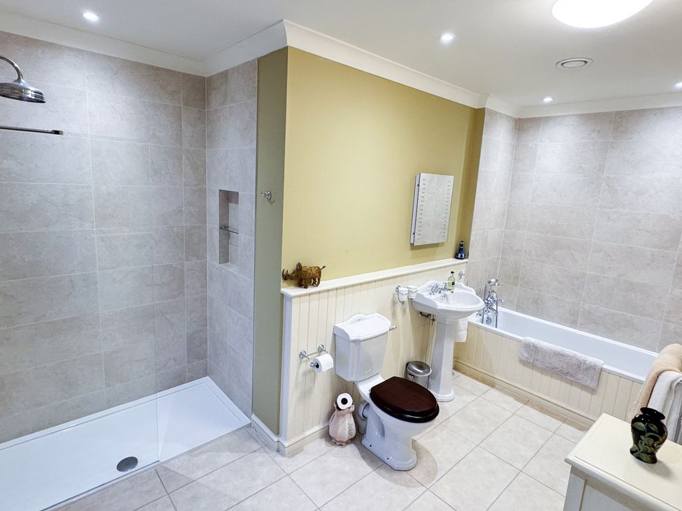 A bathroom with a shower, toilet, sink, and bathtub at Uphill Manor in Uphill near Weston-Super-Mare