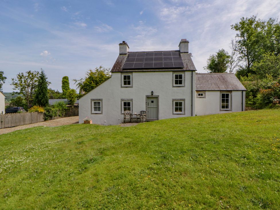 A house with solar panels and grass area at Cynefin in Newport, Pembrokeshire