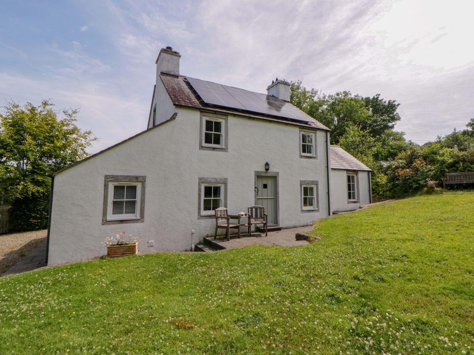 A house with solar panels and patio area at Cynefin in Newport, Pembrokeshire