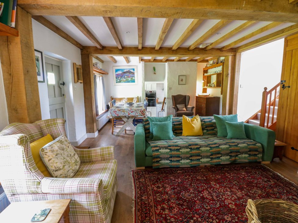 A living room with sofa and armchair at Cynefin in Newport, Pembrokeshire