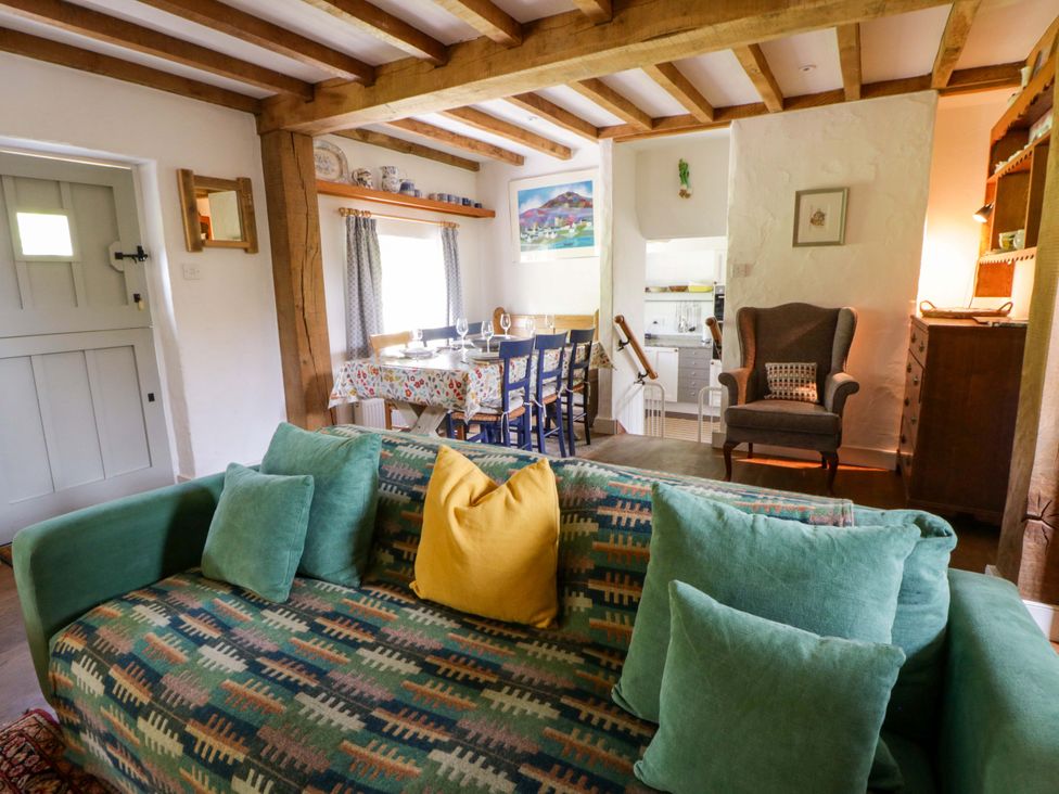 A living room with a dining table and chairs at Cynefin Newport, Pembrokeshire