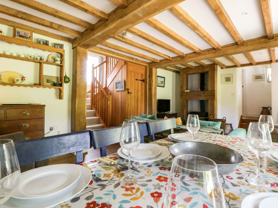 A dining room with a table set for meals at Cynefin in Newport, Pembrokeshire