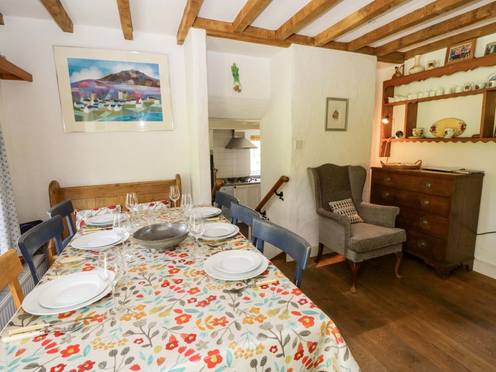 A dining room with a table set for dinner at Cynefin in Newport, Pembrokeshire