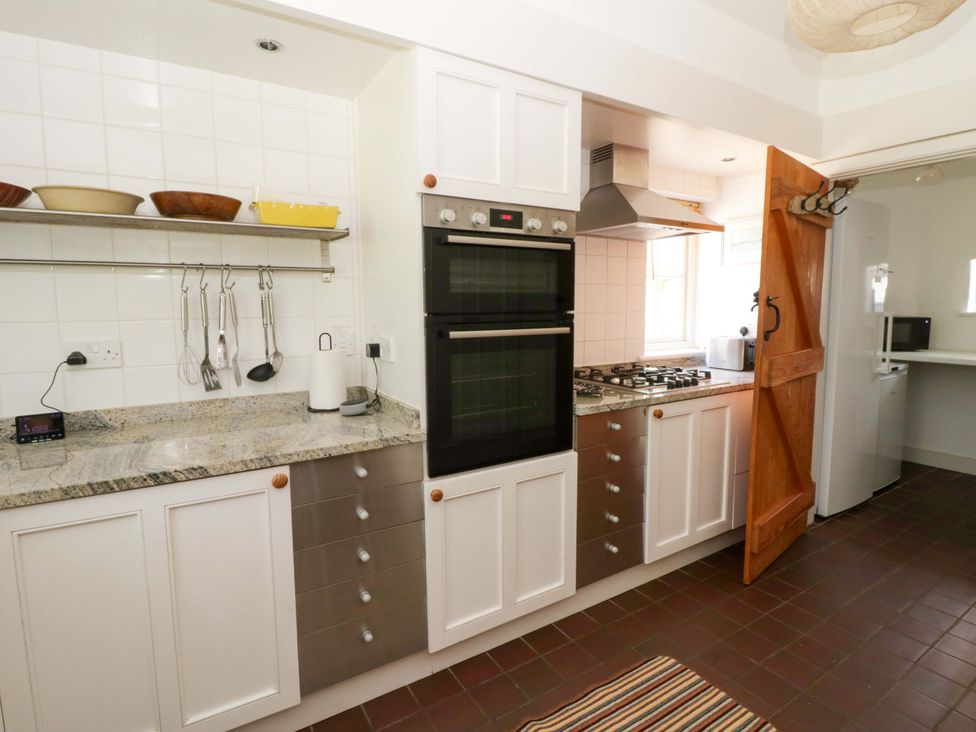 A kitchen with appliances and countertops at Cynefin Newport, Pembrokeshire