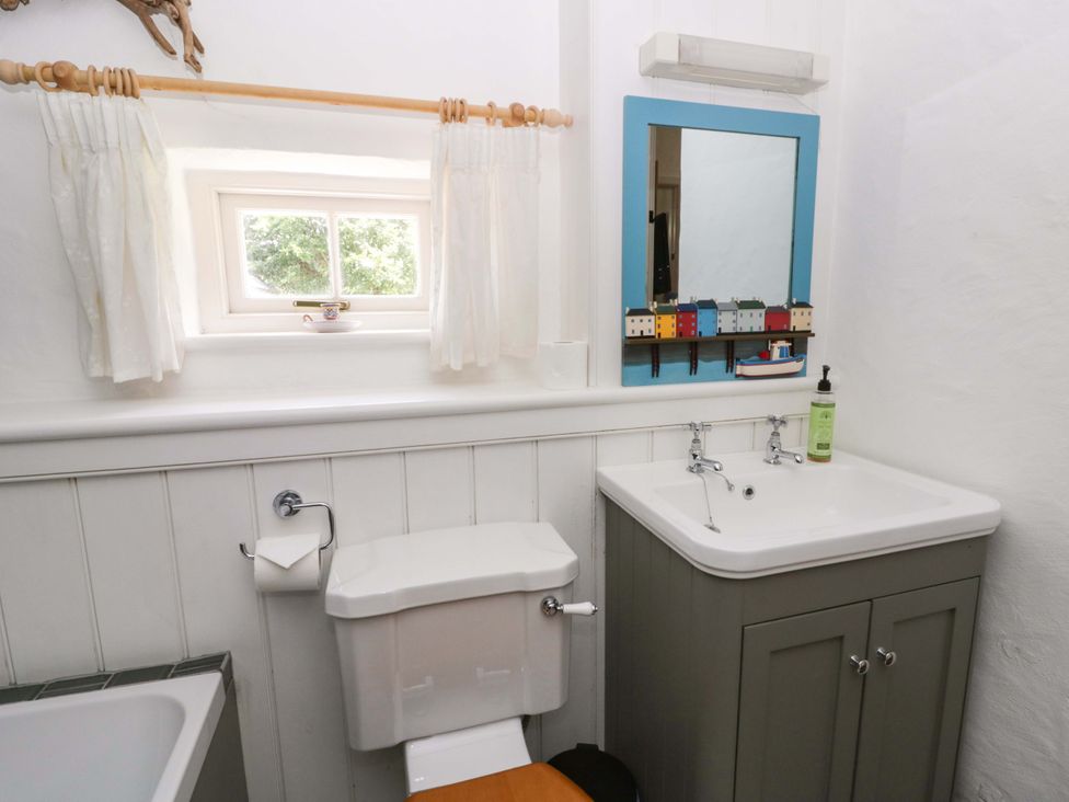 A bathroom with a toilet and sink at Cynefin, Newport, Pembrokeshire