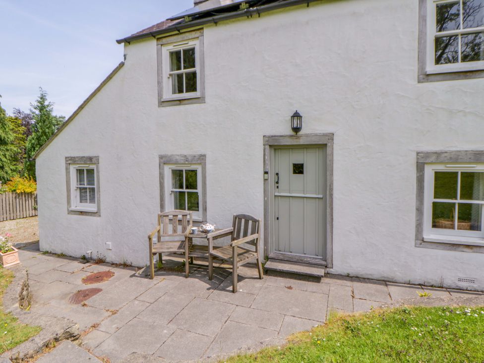 An outdoor seating area with chairs and a table at Cynefin, Newport, Pembrokeshire