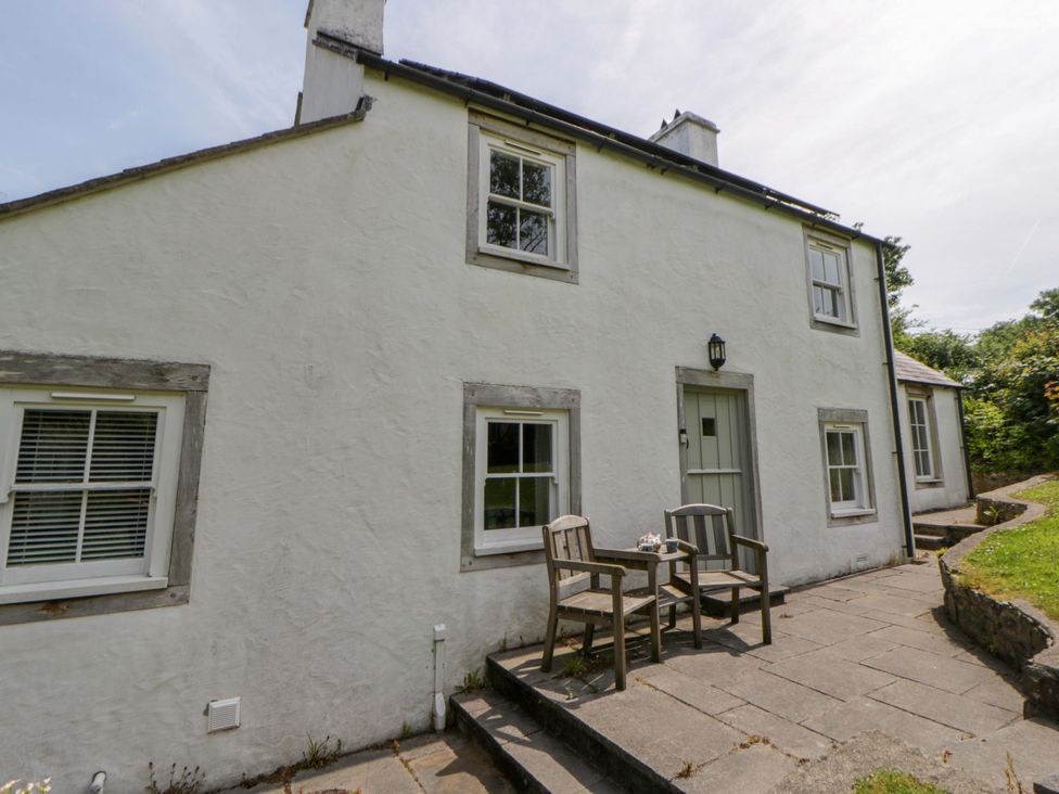 A house with a table and chairs on the patio at Cynefin in Newport, Pembrokeshire