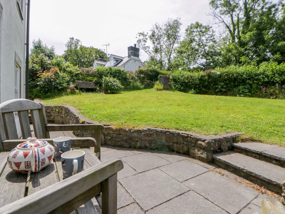 A garden with a teapot and mugs on a table at Cynefin in Newport, Pembrokeshire