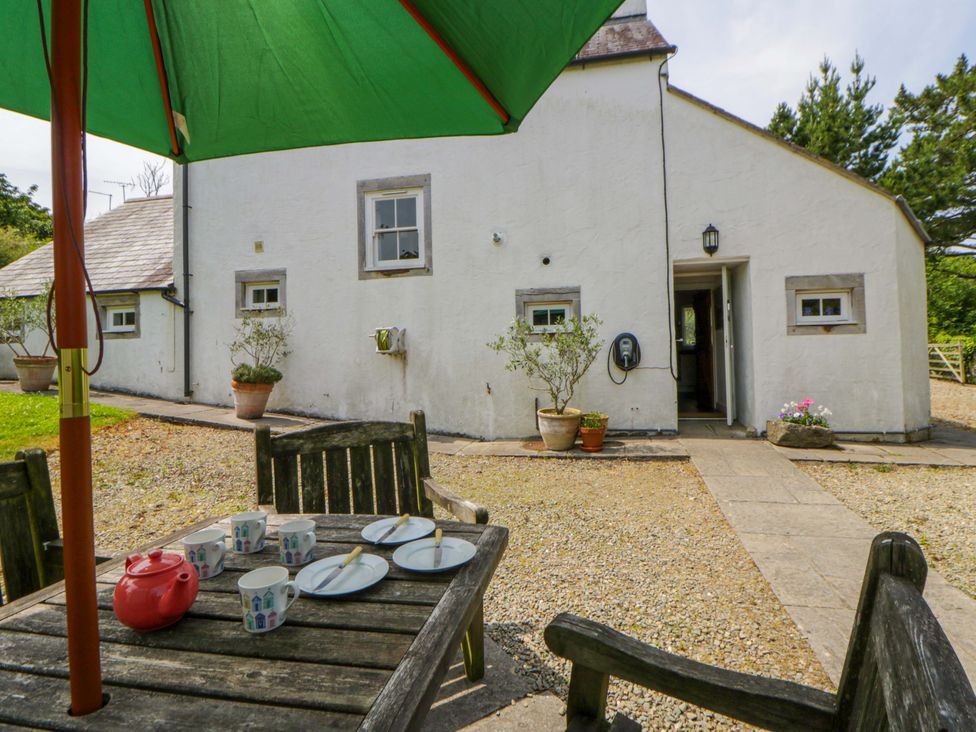 An outdoor dining area with a table and chairs at Cynefin, Newport, Pembrokeshire