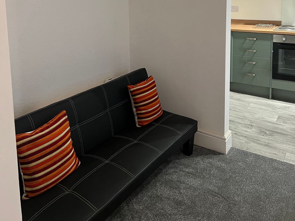 A kitchen with a couch and pillows at Little Marrakesh Lodge in Worcester