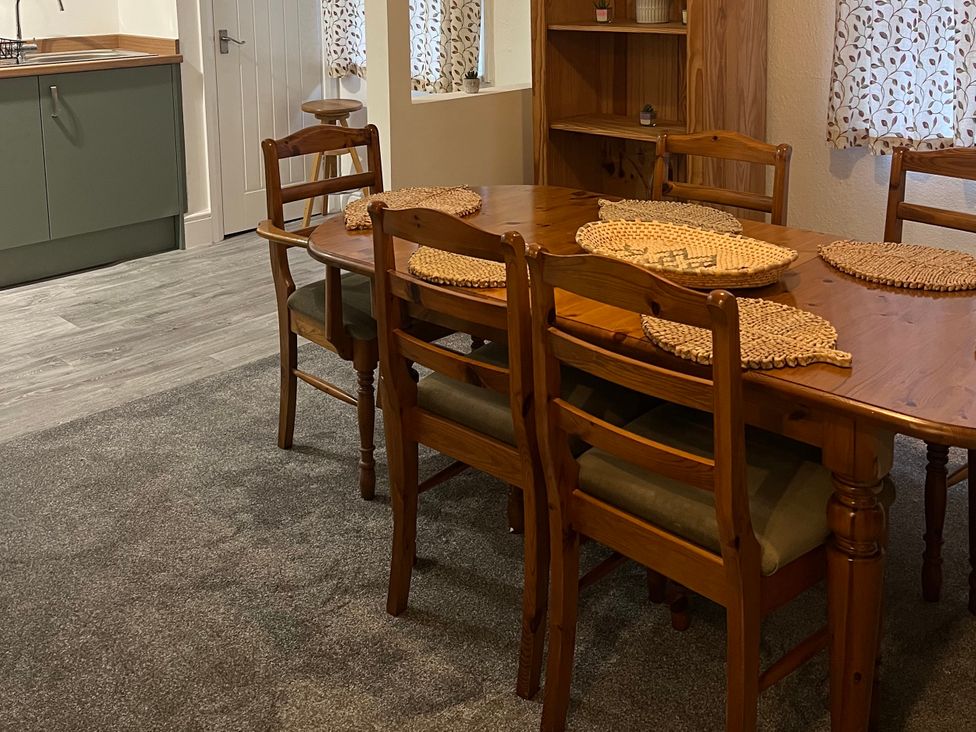 A dining room with wooden table and chairs at Little Marrakesh Lodge in Worcester
