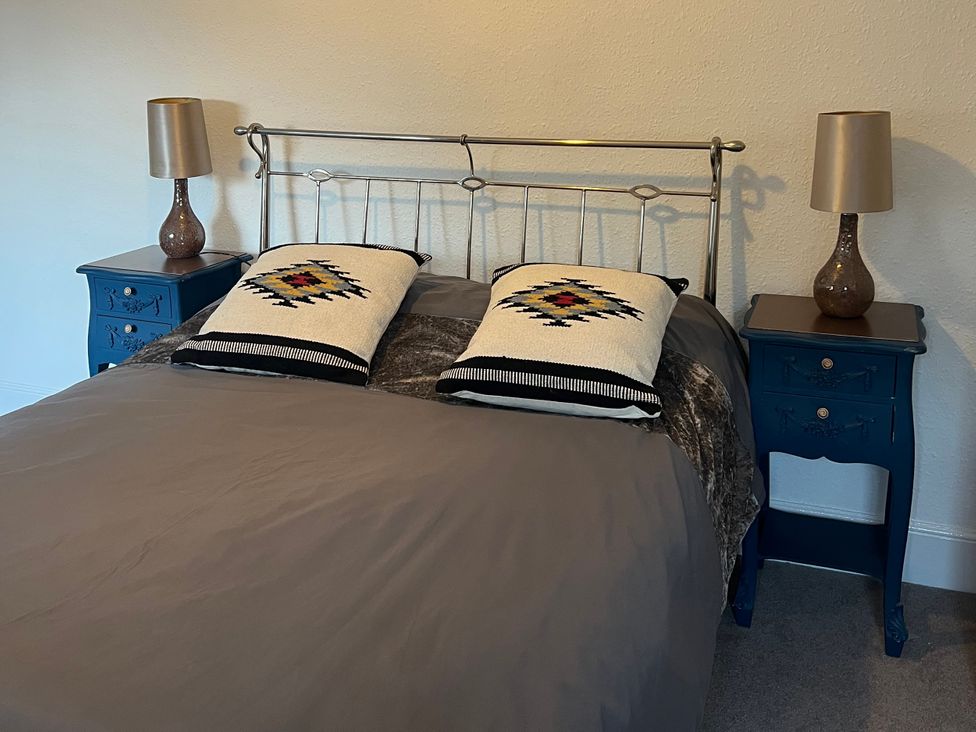 A bed with pillows and nightstands with lamps at Little Marrakesh Lodge in Worcester