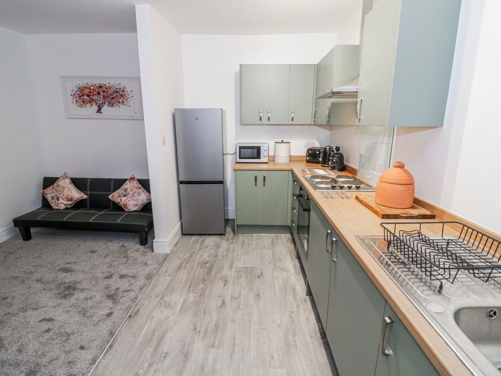 A kitchen with appliances and a sofa at Little Marrakesh Lodge in Worcester