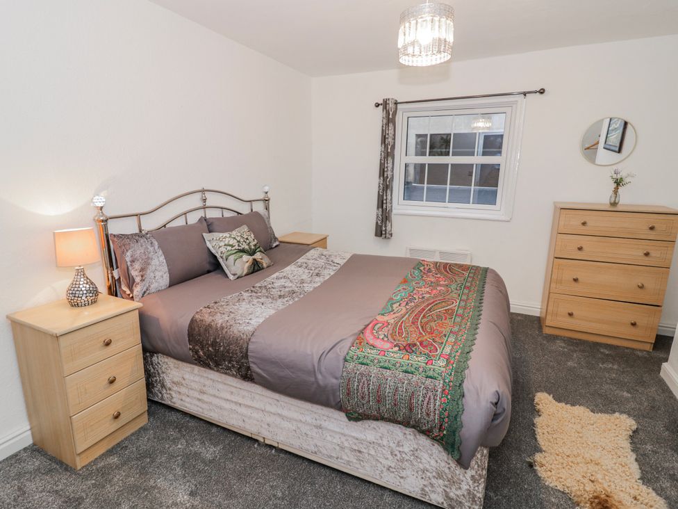 A bedroom with a bed and bedside table at Little Marrakesh Lodge in Worcester