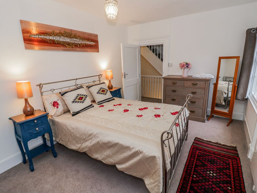 A bedroom with a bed and nightstand at Little Marrakesh Lodge in Worcester