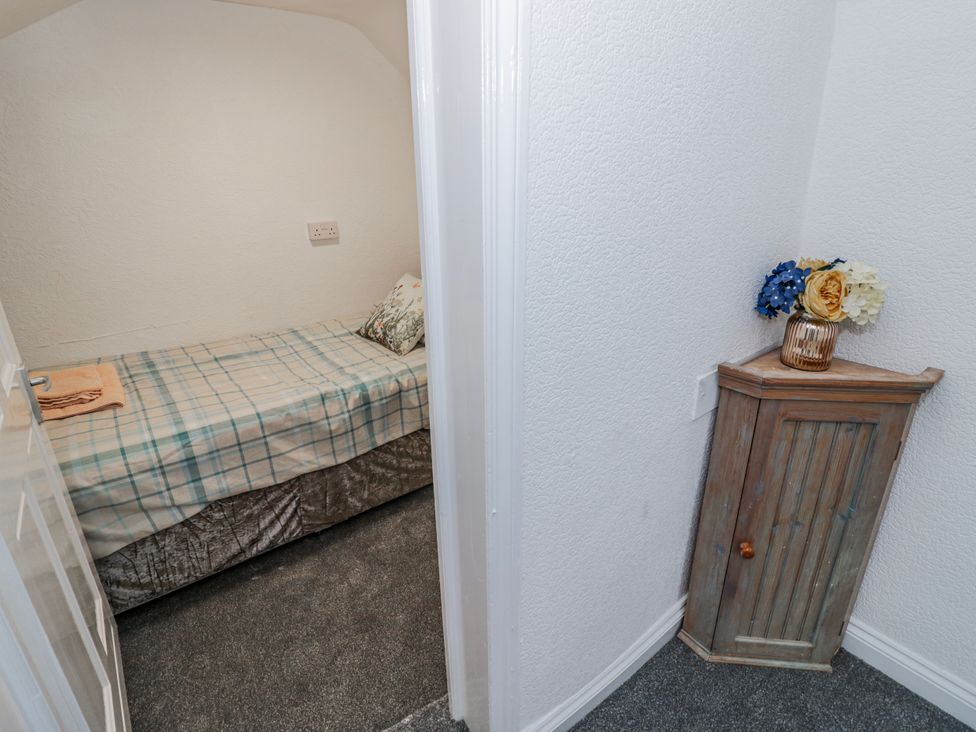 A bedroom with a bed and a corner cabinet at Little Marrakesh Lodge in Worcester