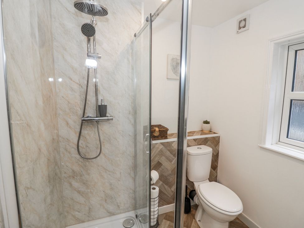 A bathroom with a shower, toilet, and window at Little Marrakesh Lodge in Worcester