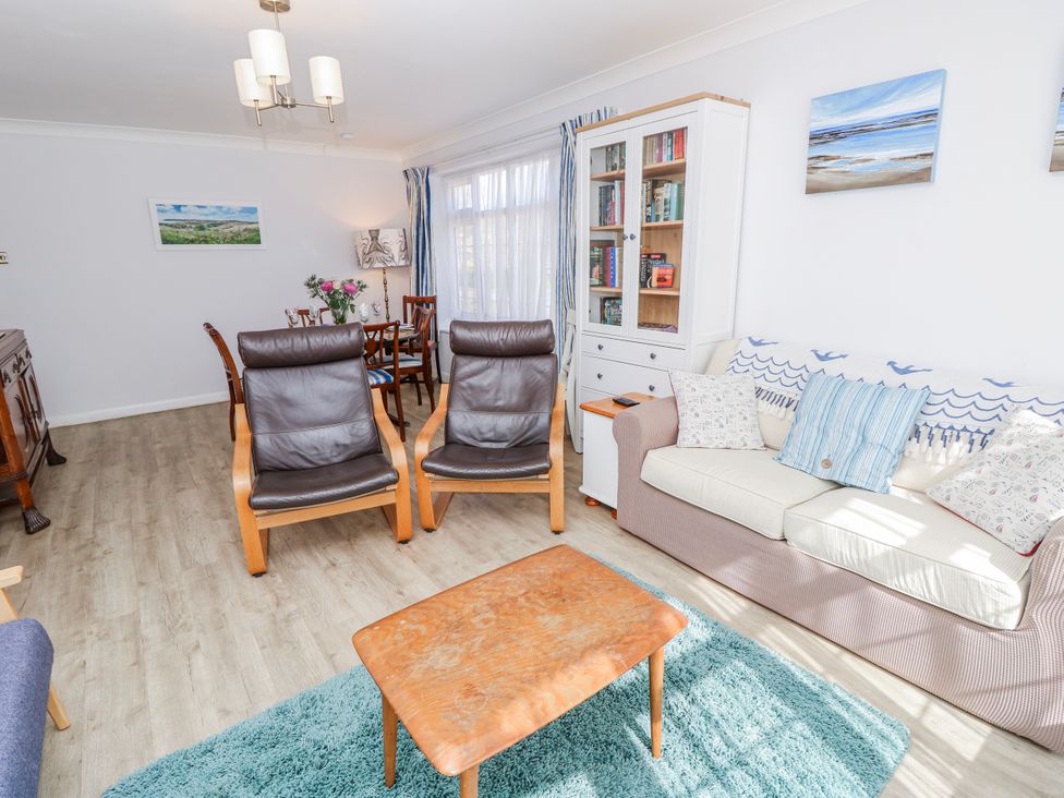 A living room with chairs and a table at 2 Trelawny Way in Bembridge