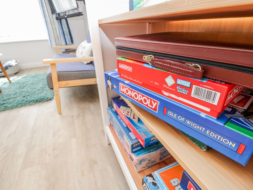 A shelf with board games including Monopoly at 2 Trelawny Way Bembridge