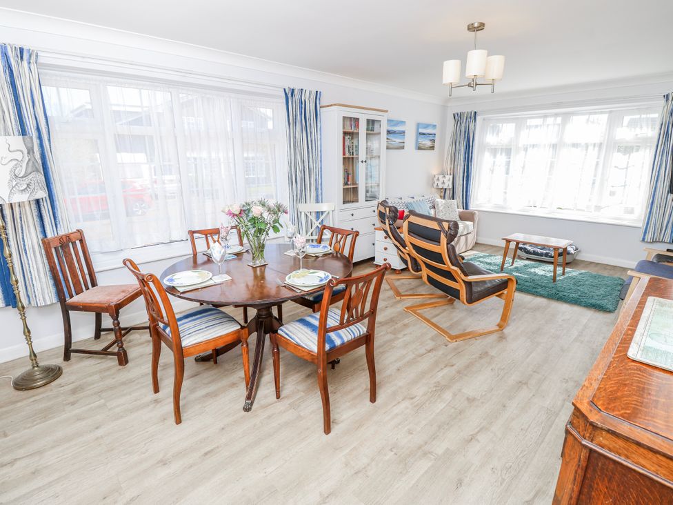 A dining room with a table and chairs at 2 Trelawny Way in Bembridge