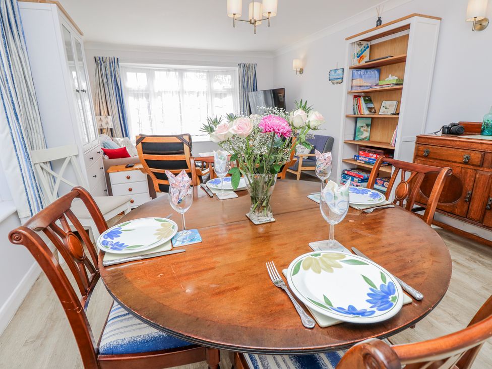A dining table with a flower vase at 2 Trelawny Way in Bembridge