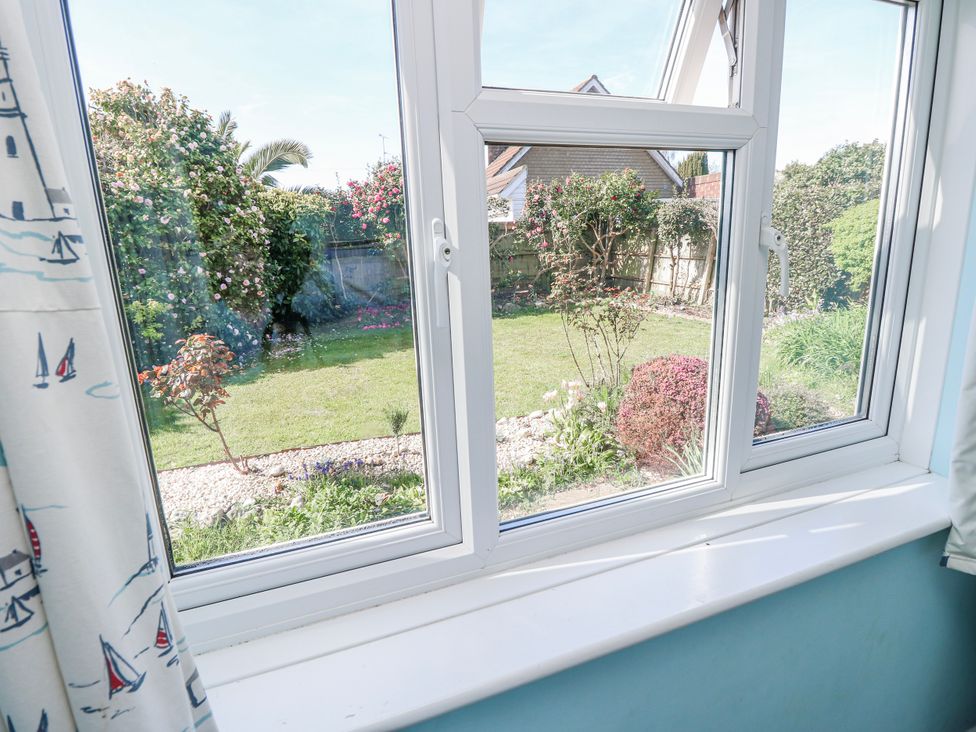 View from a window into a garden at 2 Trelawny Way in Bembridge