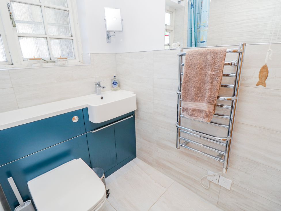 A bathroom with a sink and towel rack at 2 Trelawny Way in Bembridge