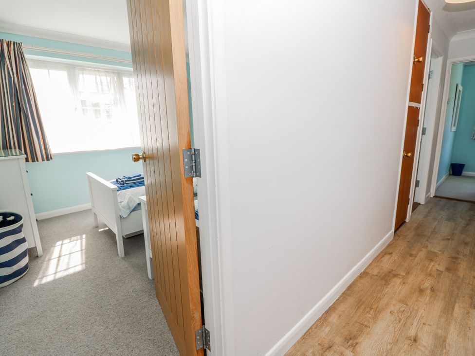 A bedroom featuring a bed and a door at 2 Trelawny Way in Bembridge