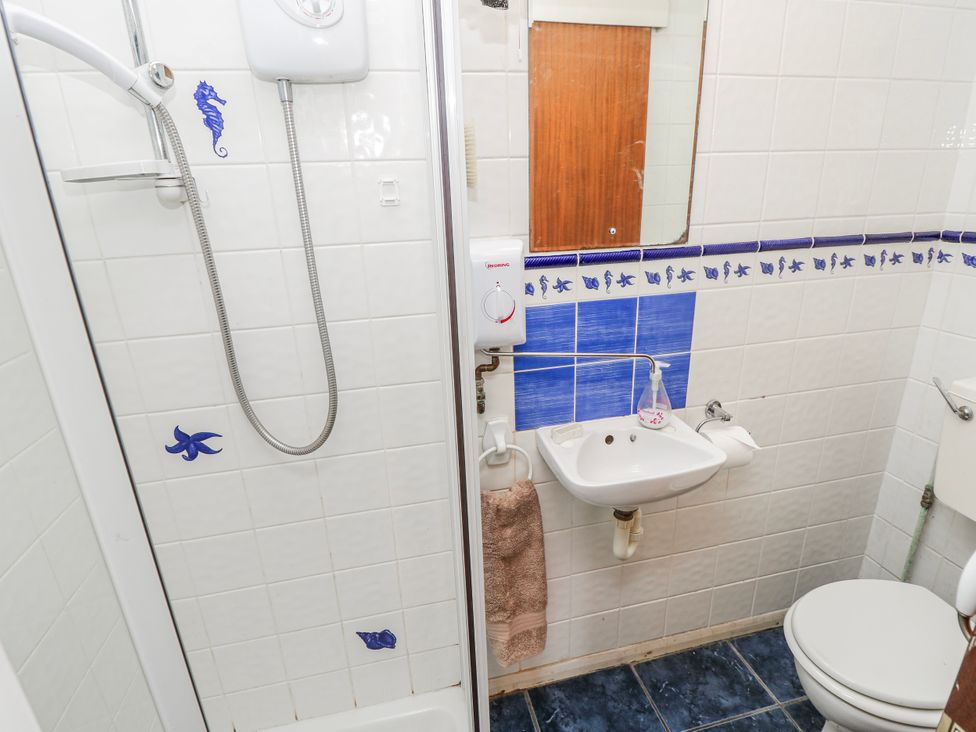 A bathroom featuring a shower, sink, and toilet at 2 Trelawny Way Bembridge