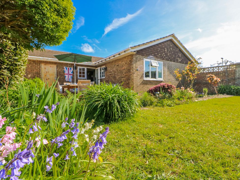 A garden with flowers and outdoor furniture at 2 Trelawny Way in Bembridge