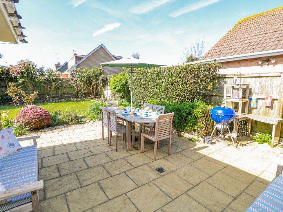 A garden with outdoor dining setup at 2 Trelawny Way in Bembridge