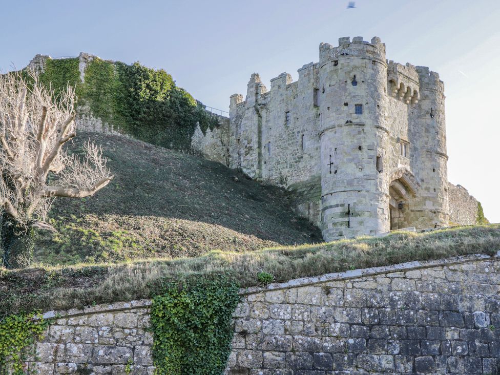 A castle on a hill with stone walls and trees at 2 Trelawny Way in Bembridge