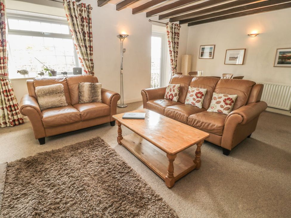 A living room with sofas and a coffee table at Shepherds Nook in Chathill