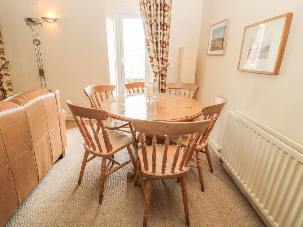A dining room with a round table and chairs at Shepherds Nook in Chathill